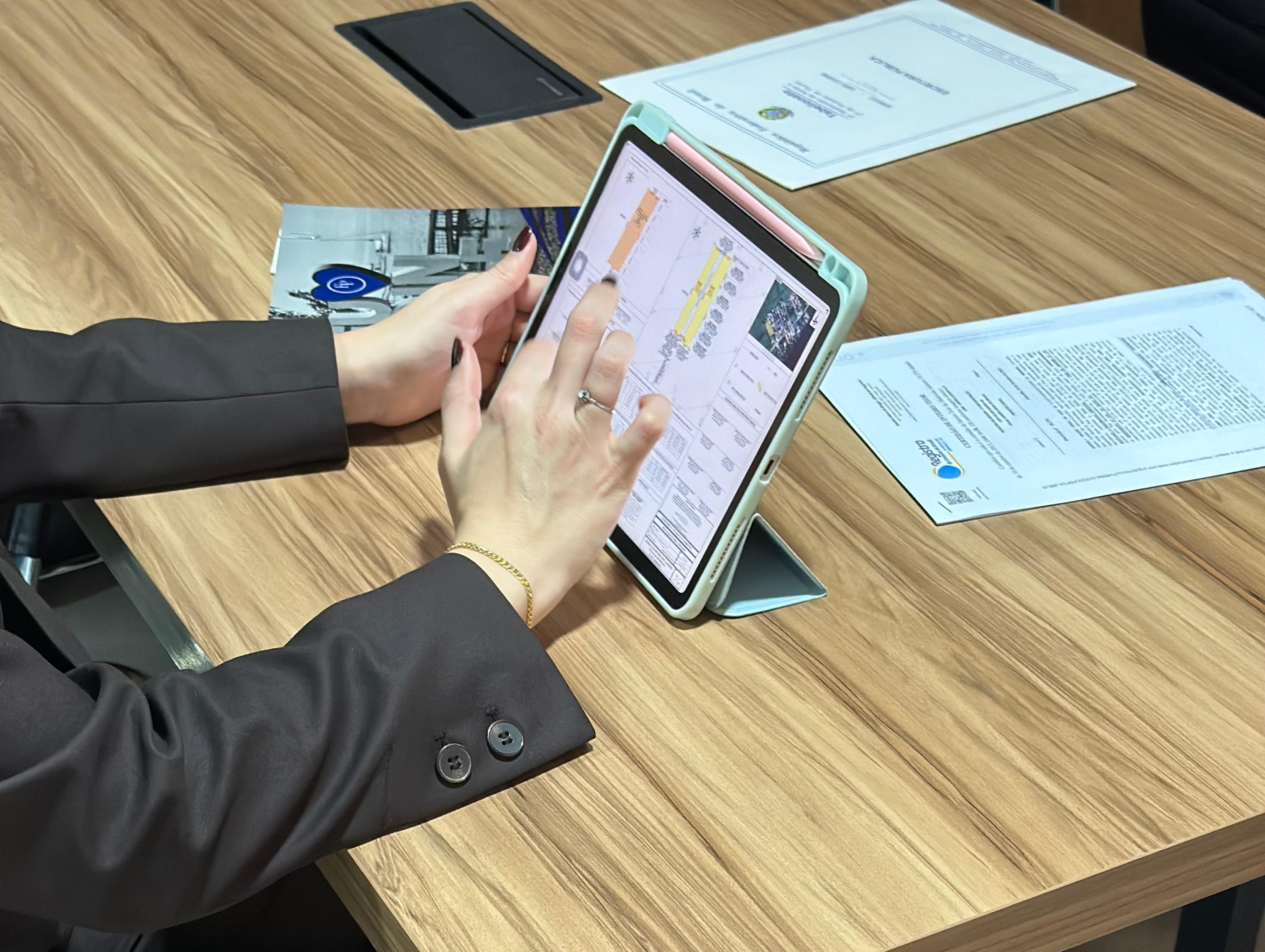 Mariah Seemann analisando levantamento de imóvel em tablet